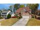 Inviting two-story home with an attached garage and a lush green lawn at 3270 River Summit Trl, Duluth, GA 30097