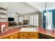 Open kitchen with view to living room, tile countertops, wood cabinets, wood floors, and stainless steel sink at 3270 River Summit Trl, Duluth, GA 30097
