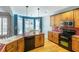 Well-lit kitchen features wood cabinets, stainless steel appliances, and a tiled countertop island at 3270 River Summit Trl, Duluth, GA 30097