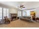 Cozy living room with fireplace, carpeted floors, view of the kitchen, plantation shutters and comfortable seating at 3270 River Summit Trl, Duluth, GA 30097