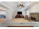Spacious living room with a stone fireplace, ceiling fan, and a large window for lots of natural light at 3270 River Summit Trl, Duluth, GA 30097
