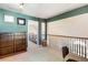 Spacious loft area with built-in shelves and neutral carpeting overlooking the entry foyer at 3270 River Summit Trl, Duluth, GA 30097