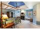 Bright main bedroom boasts fireplace, tray ceiling, and window seat for relaxing at 3270 River Summit Trl, Duluth, GA 30097