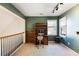 Upstairs office featuring wainscoting, built-in shelves, and great natural light at 3270 River Summit Trl, Duluth, GA 30097