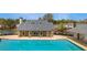 A spacious swimming pool and bathhouse situated next to a serene lake at 3270 River Summit Trl, Duluth, GA 30097