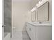Bathroom with double sinks, two mirrors, and modern fixtures, and a large tub at 556 James P Brawley Nw Dr, Atlanta, GA 30318