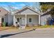 Charming bungalow with a fresh coat of gray paint, complemented by a crisp white door and trim, nestled in a friendly neighborhood at 556 James P Brawley Nw Dr, Atlanta, GA 30318