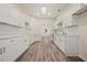 Spacious kitchen with sleek white cabinets, countertops, and subway tile backsplash, providing a modern culinary experience at 556 James P Brawley Nw Dr, Atlanta, GA 30318
