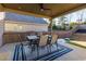 Relaxing covered patio features an outdoor dining area, and a peaceful backyard with landscaping at 211 Orchard Trl, Canton, GA 30115
