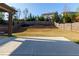 Backyard features a concrete patio and a well-maintained lawn with layered landscaping at 211 Orchard Trl, Canton, GA 30115