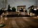 View of backyard with stone retaining wall, attractive fence lighting, and lush landscaping creates an inviting outdoor space at 211 Orchard Trl, Canton, GA 30115