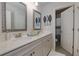 Bathroom with double vanity, framed mirrors, decorative wall art, and an adjacent toilet room with a shower at 211 Orchard Trl, Canton, GA 30115