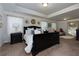 Elegant primary bedroom featuring a large bed, tray ceiling, carpet, and decorative accents and lighting at 211 Orchard Trl, Canton, GA 30115