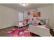 Charming bedroom with twin beds, colorful accents, and whimsical wall art creating a playful atmosphere at 211 Orchard Trl, Canton, GA 30115