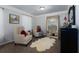 Sitting area located in the primary bedroom featuring chairs and an ornate full length mirror at 211 Orchard Trl, Canton, GA 30115