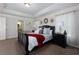 Elegant primary bedroom with tray ceiling and carpeting featuring a large bed and decorative accents at 211 Orchard Trl, Canton, GA 30115