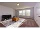 Bonus room with plenty of natural light from three windows featuring a leather storage ottoman at 211 Orchard Trl, Canton, GA 30115