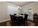 Dining room featuring dark wood table, chairs, and access to outdoor patio at 211 Orchard Trl, Canton, GA 30115