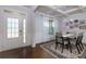 Bright dining room featuring a coffered ceiling, modern chandelier, and a glass-top dining table at 211 Orchard Trl, Canton, GA 30115