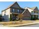 Attractive two-story home with brick and siding, showcasing a neat lawn and inviting front porch at 211 Orchard Trl, Canton, GA 30115