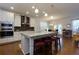 Open kitchen featuring a large island with seating, modern appliances, and stylish backsplash at 211 Orchard Trl, Canton, GA 30115