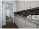 Kitchen features granite countertops, black subway tile, and white cabinets at 211 Orchard Trl, Canton, GA 30115