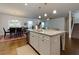 Open concept kitchen island with sink, dishwasher, and stylish pendant lighting at 211 Orchard Trl, Canton, GA 30115