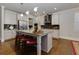 Modern kitchen with stainless steel appliances, granite countertops, and large center island at 211 Orchard Trl, Canton, GA 30115