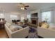 Bright living room features hardwood floors, a fireplace, and large windows allowing for plenty of natural light at 211 Orchard Trl, Canton, GA 30115