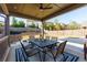 Covered patio with dining area, outdoor furniture, and a view of the well-maintained backyard, ideal for entertaining at 211 Orchard Trl, Canton, GA 30115