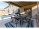 Inviting covered patio features an outdoor dining area with seating and a ceiling fan at 211 Orchard Trl, Canton, GA 30115