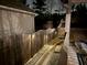 Side yard features landscape lighting, a gravel path, and an inviting area to enjoy quiet evenings outdoors at 211 Orchard Trl, Canton, GA 30115