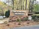 Entrance sign for Parc at Hillsdale with brick base and greenery at 35 Rumson Se Ct, Smyrna, GA 30080