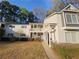 Inviting multi-level condominium with covered porch, gray siding, and well-maintained landscaping at 35 Rumson Se Ct, Smyrna, GA 30080