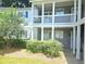 Condominium complex exterior with multiple units, covered porches, and a beautifully maintained landscaped yard at 35 Rumson Se Ct, Smyrna, GA 30080