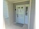 Close-up of the front entrance featuring a white door with glass and a 'Welcome' mat at 35 Rumson Se Ct, Smyrna, GA 30080