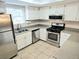 Efficient kitchen with stainless steel appliances, light cabinets, and a skylight at 35 Rumson Se Ct, Smyrna, GA 30080