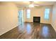 Comfortable living room with hardwood floors, fireplace, and sliding door access to patio at 35 Rumson Se Ct, Smyrna, GA 30080