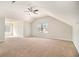 Spacious bedroom with a vaulted ceiling, large windows, and neutral carpet at 498 Pecan Wood Cir, Fairburn, GA 30213