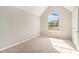 Bright bedroom with vaulted ceiling and large arched window offering neighborhood views at 498 Pecan Wood Cir, Fairburn, GA 30213