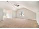 Expansive carpeted bedroom featuring a ceiling fan, large window, and vaulted ceilings at 498 Pecan Wood Cir, Fairburn, GA 30213