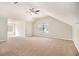 Large bonus room with high ceilings, natural light, and plush carpet at 498 Pecan Wood Cir, Fairburn, GA 30213