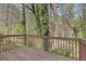 Wooden deck surrounded by lush greenery, offering a private outdoor space at 498 Pecan Wood Cir, Fairburn, GA 30213