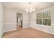 Dining room featuring a modern chandelier and view of the kitchen area at 498 Pecan Wood Cir, Fairburn, GA 30213