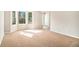 Bright empty room featuring a bay window that allows plenty of natural light at 498 Pecan Wood Cir, Fairburn, GA 30213