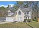 Charming two-story home with a two-car garage and well-maintained front lawn at 498 Pecan Wood Cir, Fairburn, GA 30213