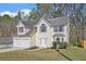 Charming two-story home with a two-car garage and well-manicured front lawn at 498 Pecan Wood Cir, Fairburn, GA 30213