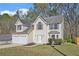 Charming two-story home featuring a two-car garage and well-maintained lawn at 498 Pecan Wood Cir, Fairburn, GA 30213