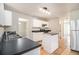 Clean kitchen with tile floor, dark countertops, and white cabinets at 498 Pecan Wood Cir, Fairburn, GA 30213