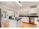 Well-lit kitchen with an island, modern appliances, and open layout to the living area at 498 Pecan Wood Cir, Fairburn, GA 30213